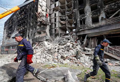 Työntekijät raivasivat sunnuntaina tuhoutuneen rakennuksen jäännöksiä ukrainalaisessa Mariupolin kaupungissa, jonka valloittaminen on yksi Venäjän tavoitteista. Kaupunkia on pommitettu säälittä viikkokausia.