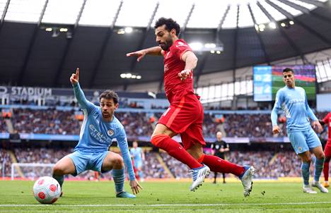 Liverpoolin Mohamed Salah yritti pitää palloa kentän puolella, Cityn Bernardo Silvalla on näkemys tilanteesta.