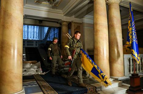 Ukrainan presidentin turvahenkilöt kantoivat maan lippua paikalle ennen presidentti Volodymyr Zelenskyn saapumista haastatteluun.