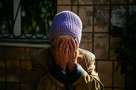 80-vuotias Luba reagoi lauantaina kranaattihyökkäykseen hautaamalla kasvot käsiinsä Bahmutissa lauantaina.