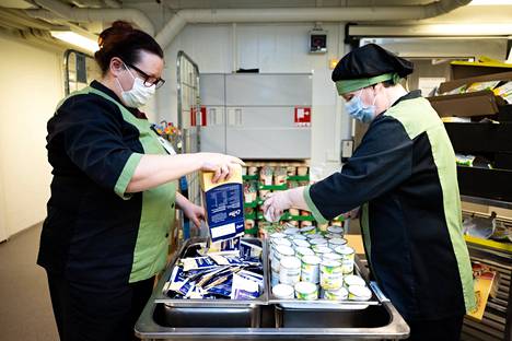 Perusopetuksen tilaamat tuhat ruokakassia ovat tällä hetkellä säilytyksessä Santalahdentiellä Tredun tiloissa. Palveluesihenkilö Sari Ylä-Outinen (vasemmalla) ja palvelutyöntekijä Tiina Roppo valmistelevat kasseja.