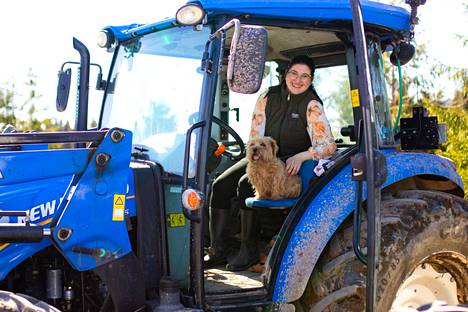 Traktorin apukuskin penkki on Liialle tuttu paikka. Santra Lähteenmäki näkee paljon hyötyjä siinä, että koirat ovat töissä mukana. 