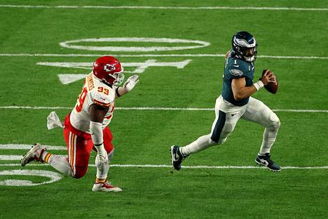 Philadelphia Eaglesin pelinrakentaja Jalen Hurts (oik.) juoksi kolme touchdownia. Hän pinkoi karkuun muun muassa Khalen Saundersilta, jonka pelipaikka löytyy Kansas City Chiefsin puolustuksen linjasta.