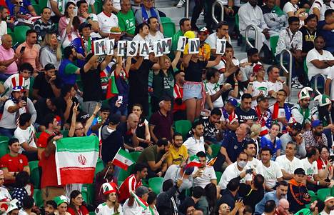 Iranin kannattajat pitelivät tiistaisessa Yhdysvallat-ottelussa Qatarissa kylttejä, joista muodostui henkensä menettäneen Mahsa Aminin nimi.