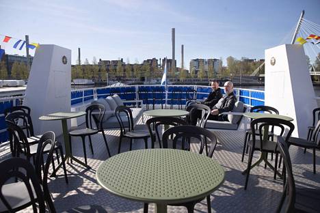 Hopealinjojen laivatoimenjohtaja Jari Niemi (takana) ja markkinointijohtaja Niko Airaksinen testaavat laivan aurinkokannella uusia istumaryhmiä.