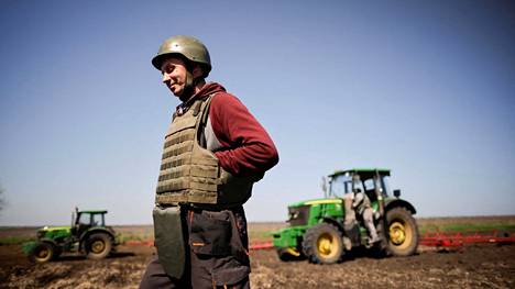 Ukrainalainen viljelijä oli varustautunut kypärällä ja luotiliivillä pellolle tiistaina 26. huhtikuuta.