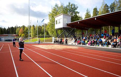 Tältä näyttää Hakkarin urheilukentän katsomo ja etusuora. Kuvassa Minna Rajamäki pitää puhetta uuden kentän avajaisissa 2019.