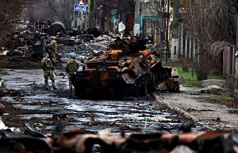 Sotilas kuvasi tuhoutuneen venäläistankin eteen asettunutta toveriaan Ukrainan Butšassa lauantaina 2. huhtikuuta.