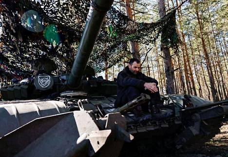Ukrainalainen sotilas istui tankin päällä etulinjan lähistöllä Kreminnan kaupungin tuntumassa Ukrainassa 14. maaliskuuta. 