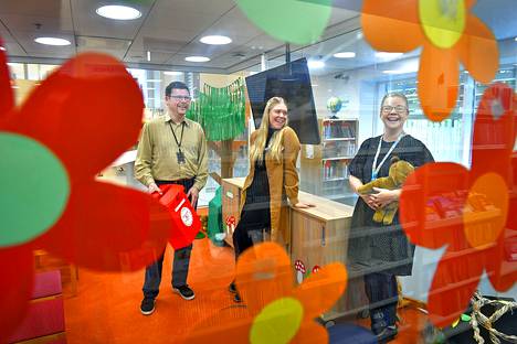 Kirjastopalvelujen johtaja Karri Hara, kirjastonhoitaja Niina Kaerla ja projektikoordinaattori Heidi Kähärä kutsuvat varhaiskasvatusikäisiä ja heidän perheitään kirjastoon Lukumaan Lumoa -hankkeella.