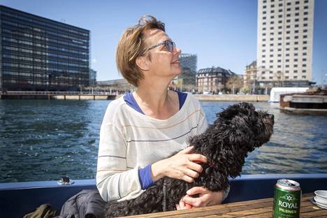 Suomesta Kööpenhaminaan muuttanut Terhi Minkkinen nauttii veneretken näkymistä Billie-koiransa kanssa. Veneeseen voi ottaa omat eväät.