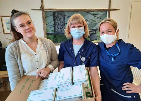 Nina Voutilainen, Taru Kangasniemi ja Meri Phair esittelevät Keuruun kotihoidon käyttämiä maskeja. Kangasniemellä on Led Expertsin lahjoittama maski ja Phairilla Navikan ompelema.