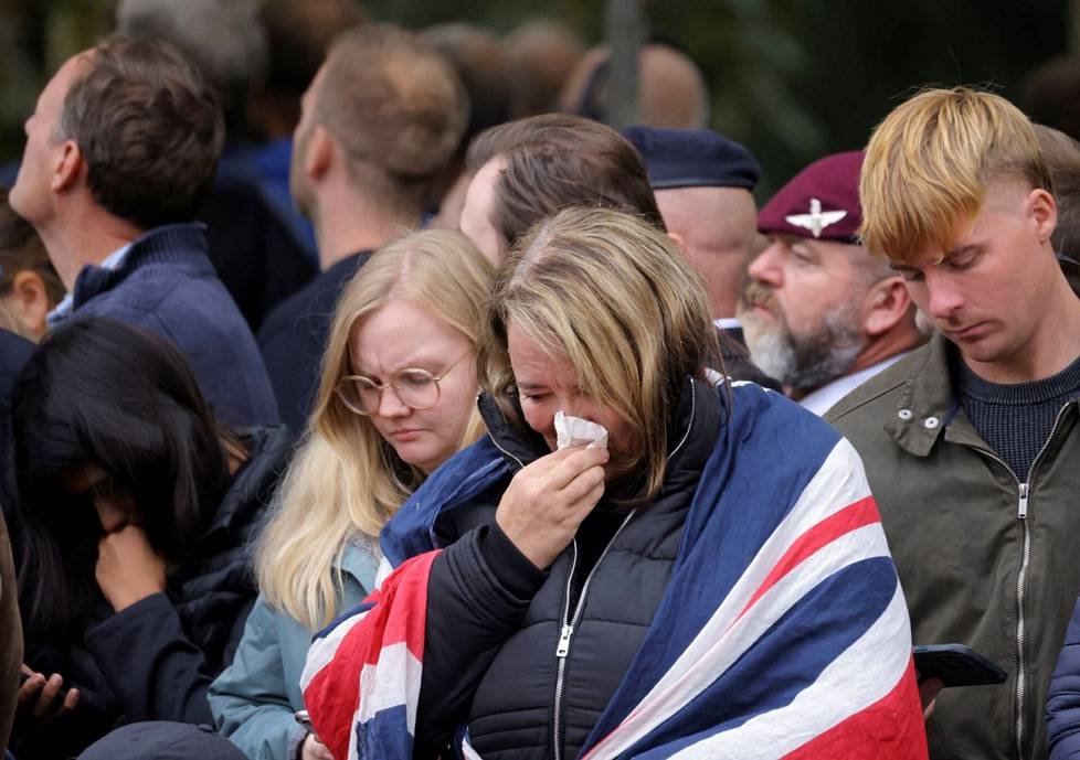 Kuningattaren hautajaisseremonia liikutti monia. Paikalle tullut oli kietonut harteilleen Britannian lipun.